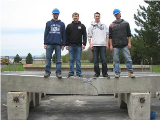 Penn State students standing on concrete beams