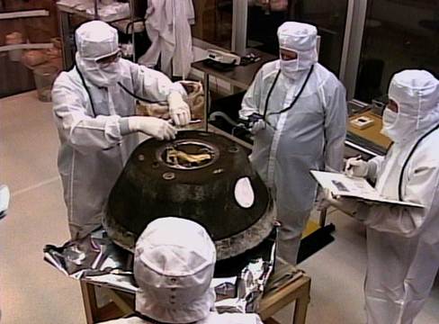 This NASA TV image shows the Stardust sample return capsule in a temporary cleanroom at the Michael Army Air Field in Utah. The capsule's science canister is safely stowed inside a special aluminum carrying case awaiting transportation to the Johnson Space Center, Houston, where it will be opened.