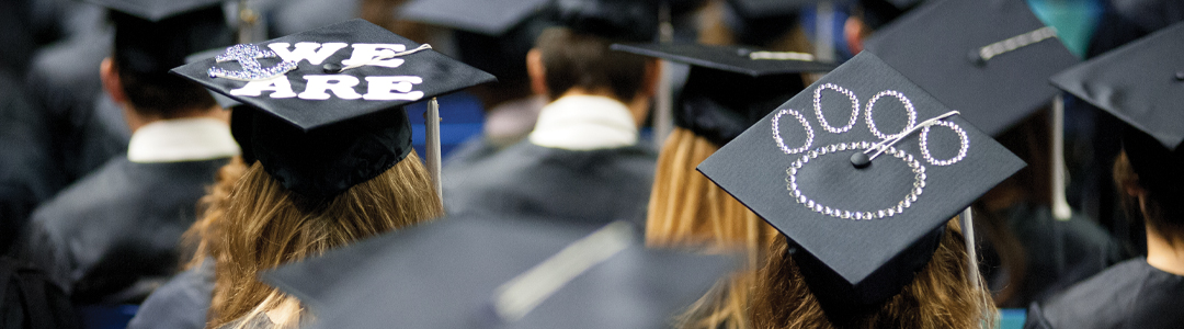 Students wear graduate caps and gowns for a ceremony