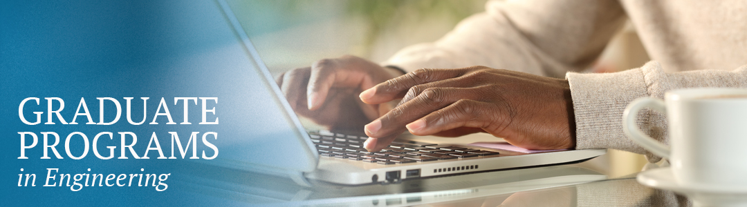 Hands typing on a laptop