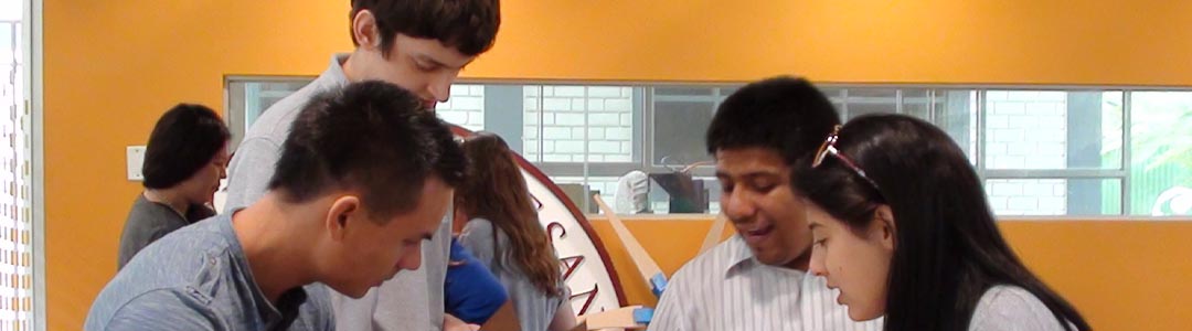 four students collaborate on a project in a classroom