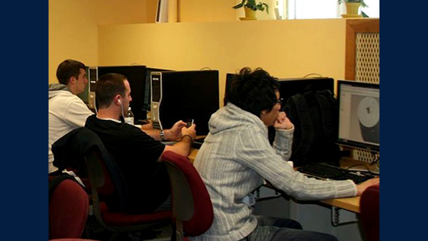 Three people sit at computers