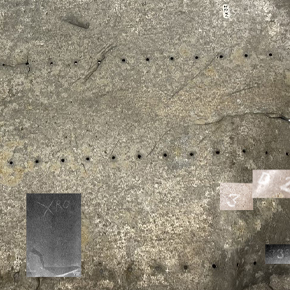 A scuffed metal panel on a white background