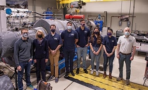 group of people standing in a turbine lab