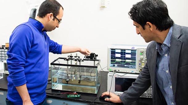 mehdi kianai and grad student in the lab