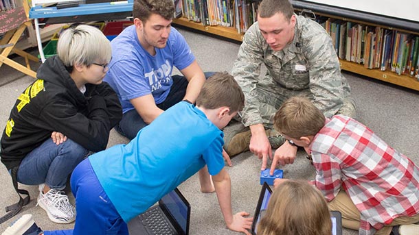 penn state students interact with elementary students