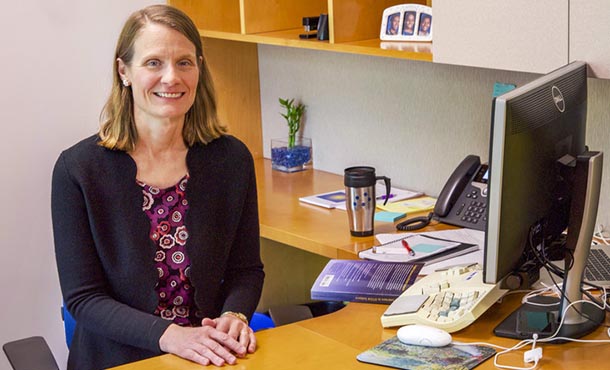 Christine Cunningham sitting at her desk