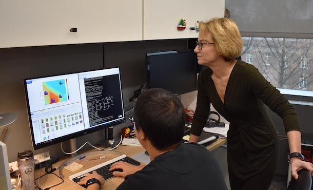 woman and man reviewing research graphics on computer