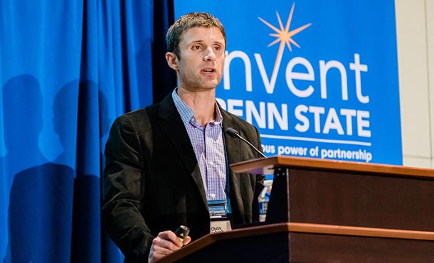 a man at a podium presents his technology at a conference