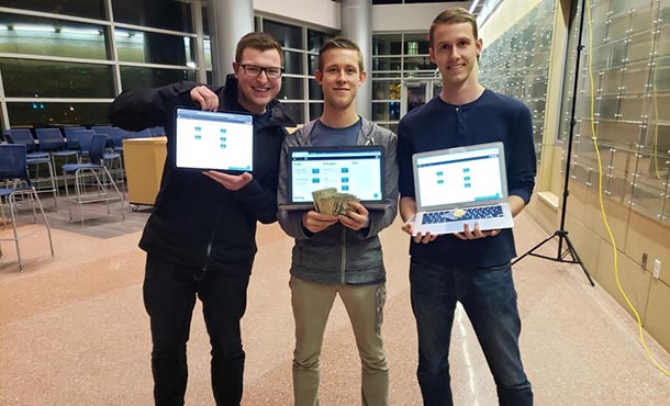 three men holding laptop computers