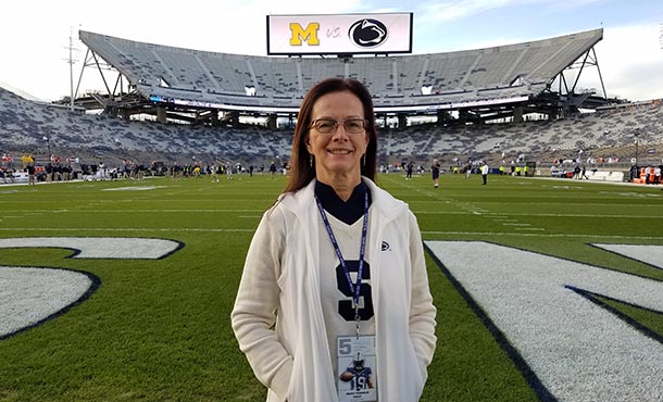 woman stands on a football field