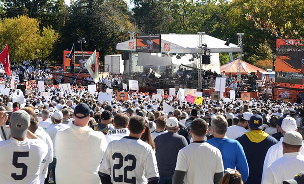 spectators stand on the HUB lawn watching college gameday broadcasters at work