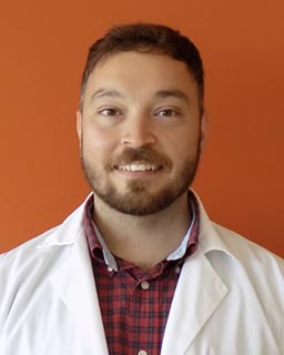 headshot of graduate student in white lab coat