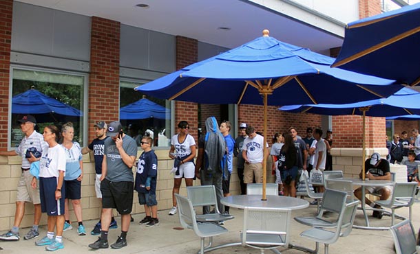 people standing in a long line outside the penn state berkey creamery