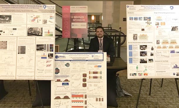 a man stands among several research posters