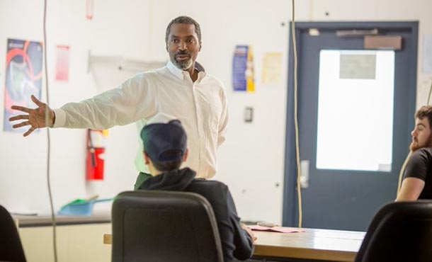 a professor gestures in front of an engineering class.