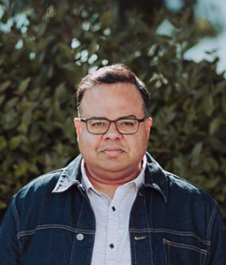 person standing in front of a bush